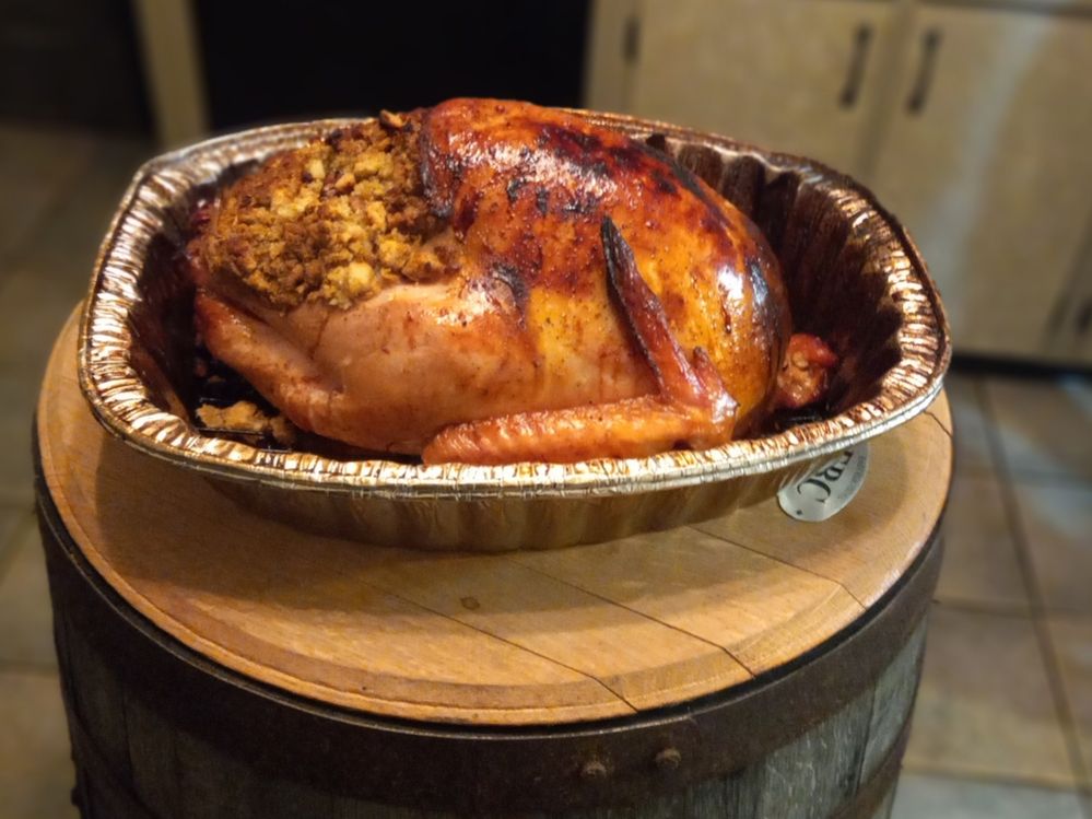smoked stuffed turkey on a barrel